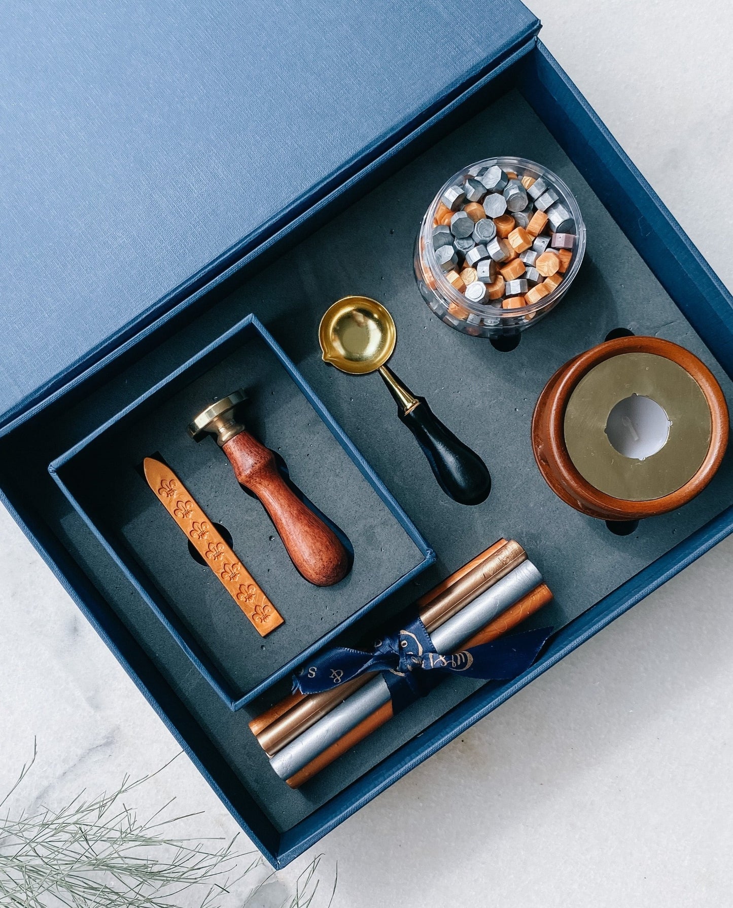 This Customized Stamp Gift Set is the perfect way to liven up your stationery. The wax sealing kit includes everything you need to craft beautiful stamps with custom logo motifs or monogram ensuring you make a unique impression. Perfect for adding a special flair to occasion cards and envelopes!